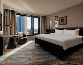 Day use room with large windows and TV at Haven Hotel Rotterdam.