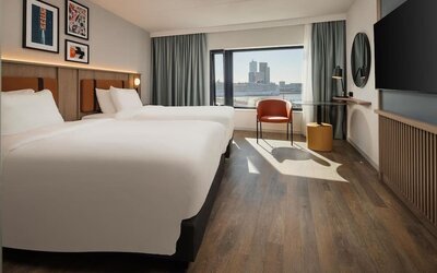 Day use room with two beds and TV at DoubleTree By Hilton Rotterdam Centre.