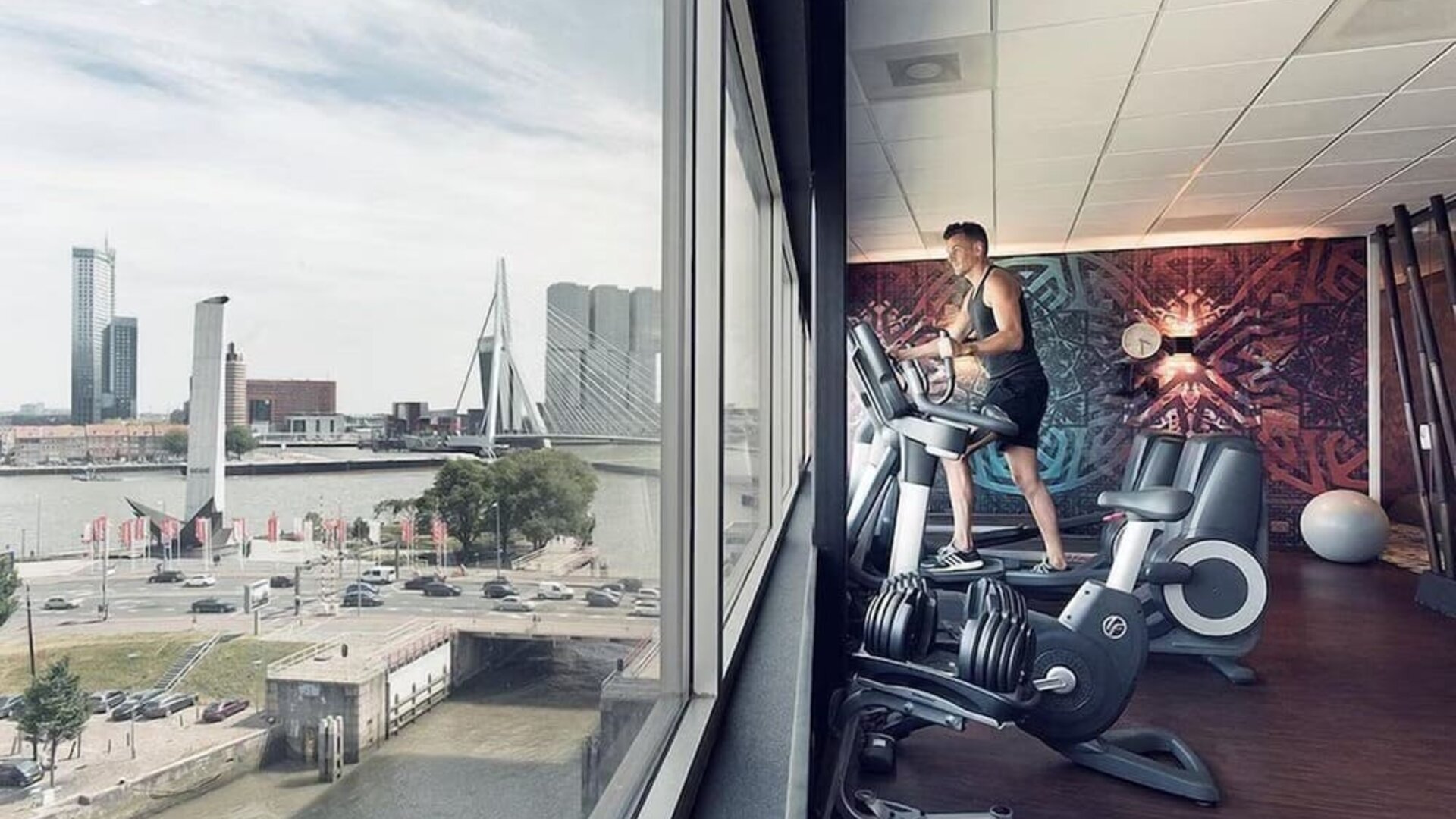 Fitness center with canal views at DoubleTree By Hilton Rotterdam Centre.