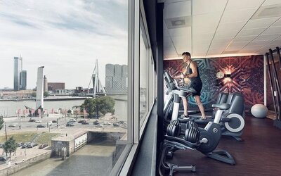Fitness center with canal views at DoubleTree By Hilton Rotterdam Centre.