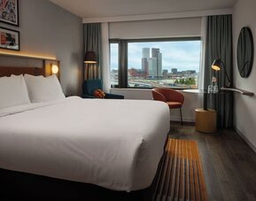 Day use room with king bed and TV at DoubleTree By Hilton Rotterdam Centre.