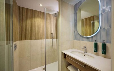 Guest bathroom with shower at DoubleTree By Hilton Rotterdam Centre.