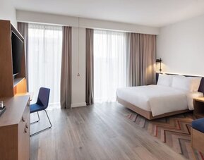 Spacious king room with TV and work desk at Hampton By Hilton Tallinn.