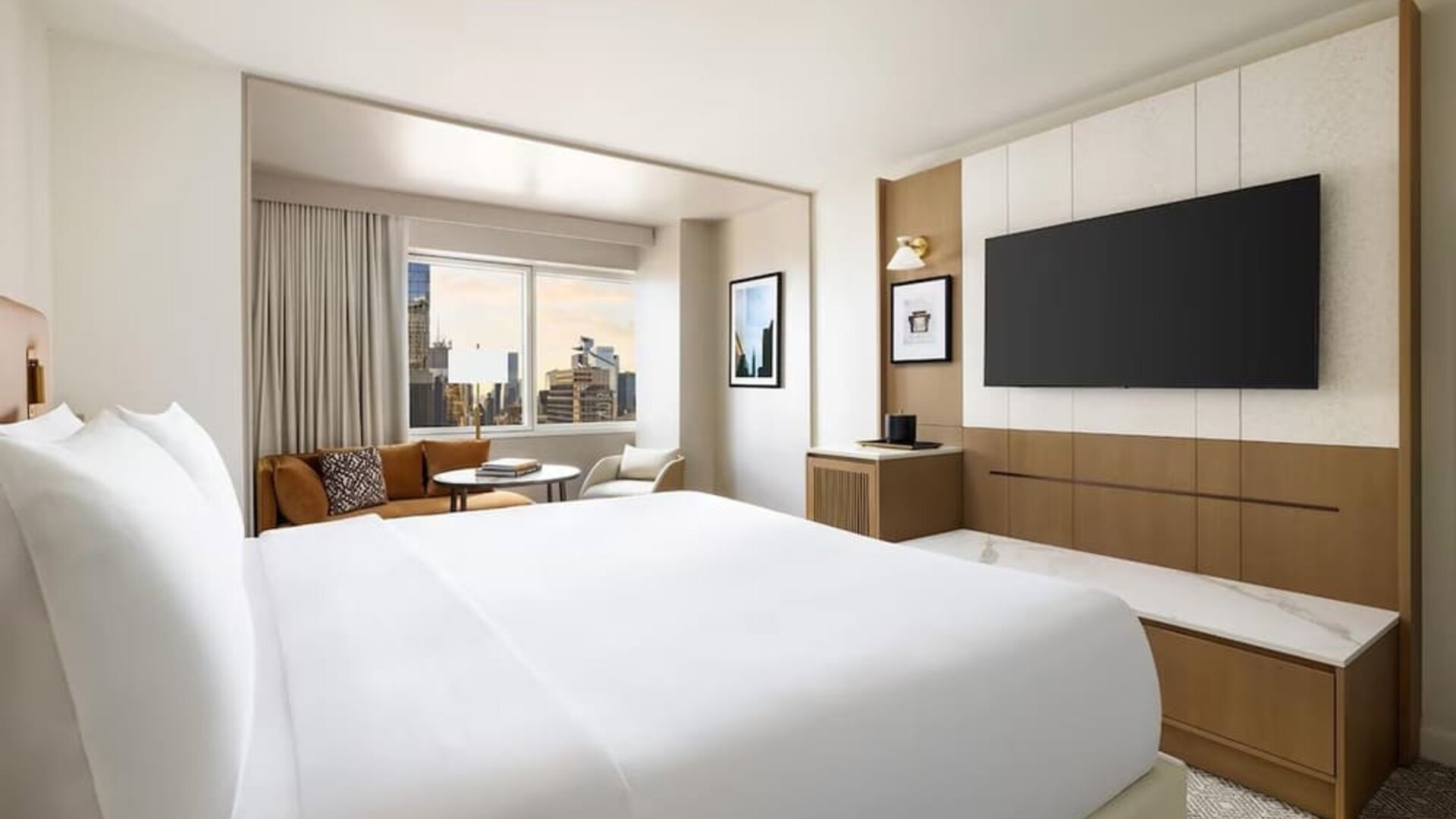 King room with bed, desk, and seating area near window at Hyatt Regency Times Square.