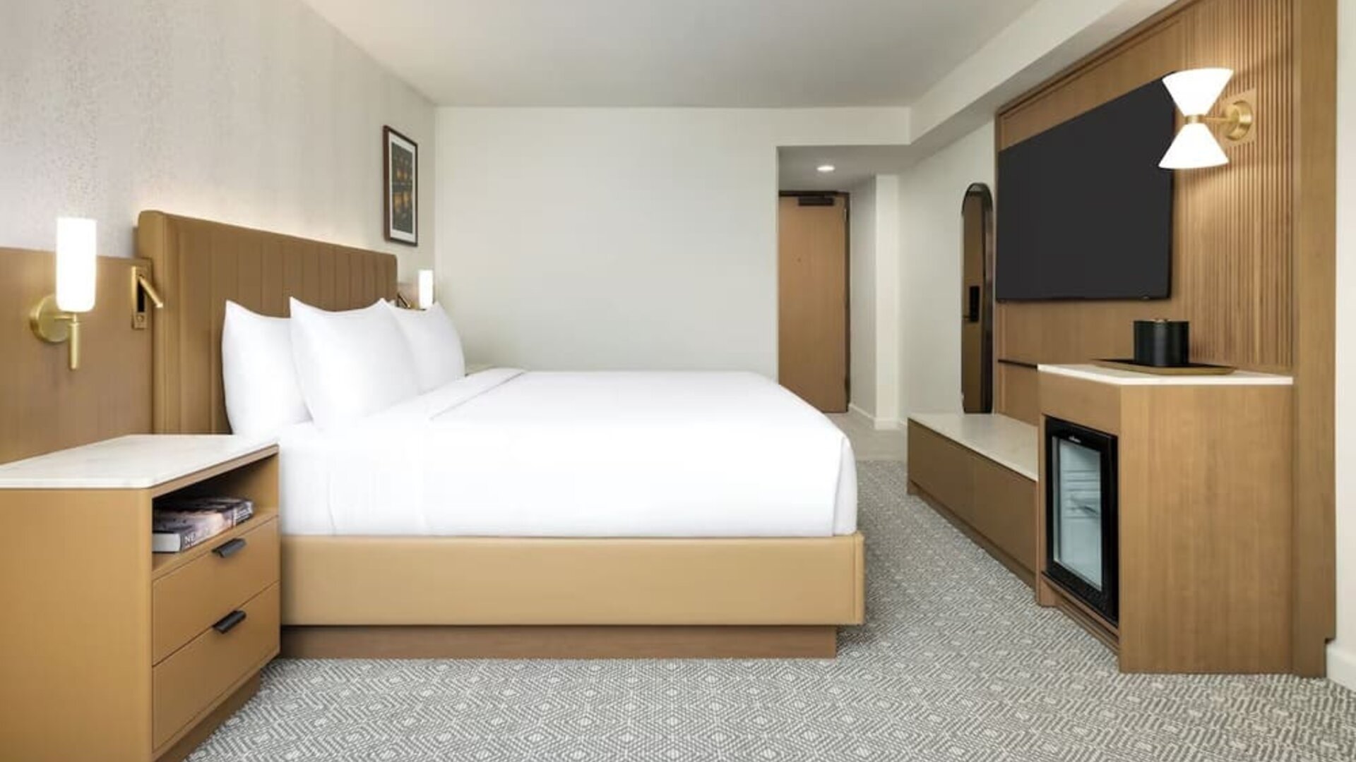 Spacious guest room with king bed, TV, and minimalist design at Hyatt Regency Times Square