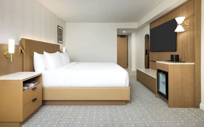 Spacious guest room with king bed, TV, and minimalist design at Hyatt Regency Times Square