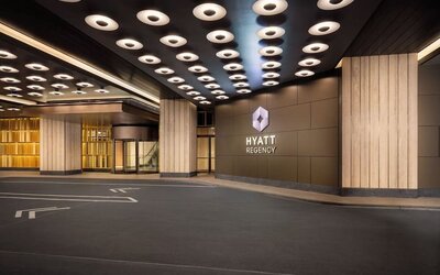 Hotel entrance with covered drop-off area and Hyatt Regency signage at Hyatt Regency Times Square.