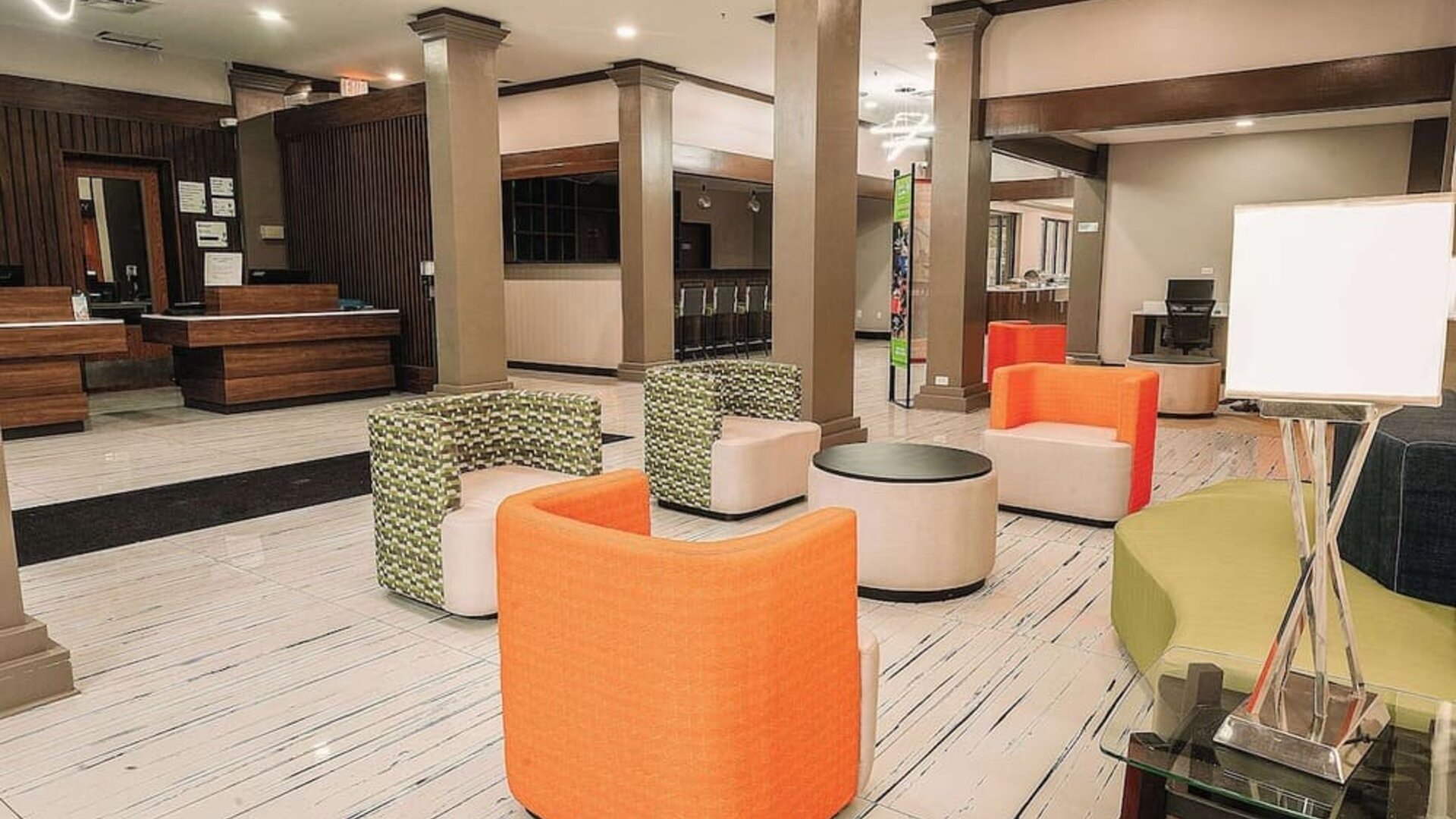 Lobby lounge with colorful seating, open space, and casual atmosphere at Wyndham Garden Williamsburg Busch Gardens Area.