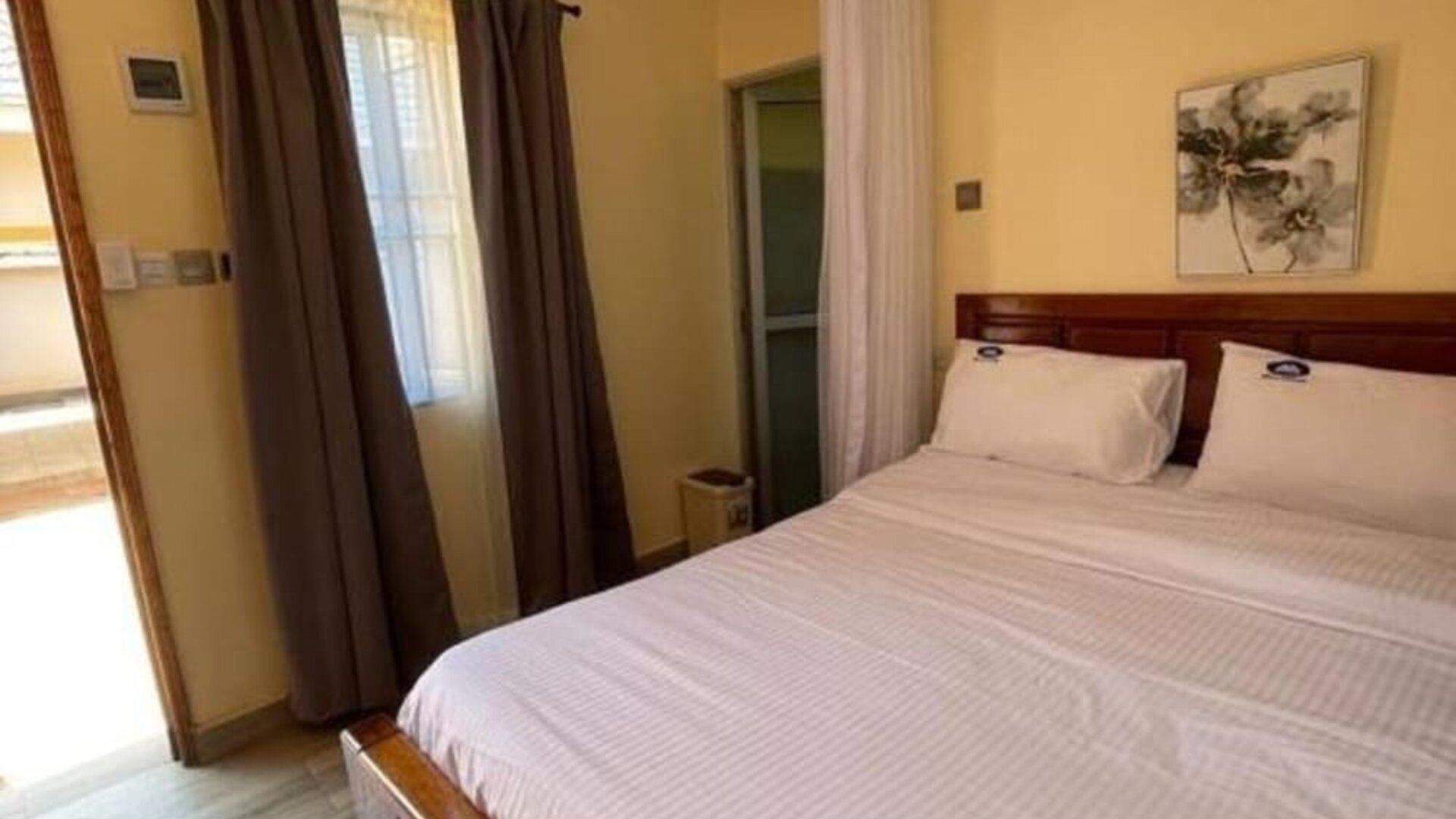 Comfortable bedroom with a large bed, soft linens, and warm lighting, offering a relaxing stay at Sega Lodge.
