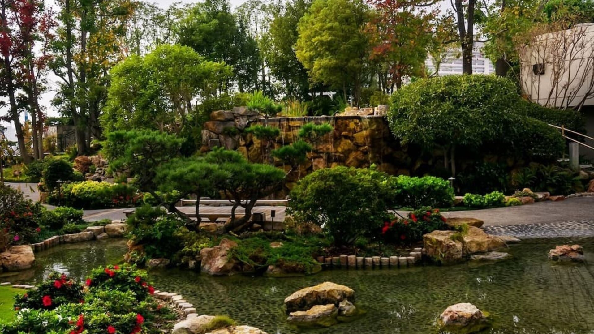 Japanese-style garden with koi pond, stone features, greenery, and landscaped walking paths at DoubleTree By Hilton Los Angeles Downtown.
