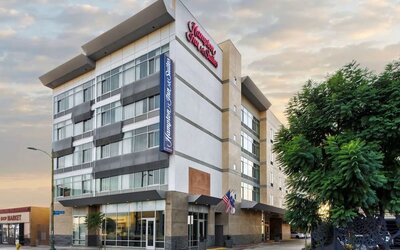 Exterior view of the hotel building with modern façade and signage at Hampton Inn & Suites Los Angeles / Hollywood.