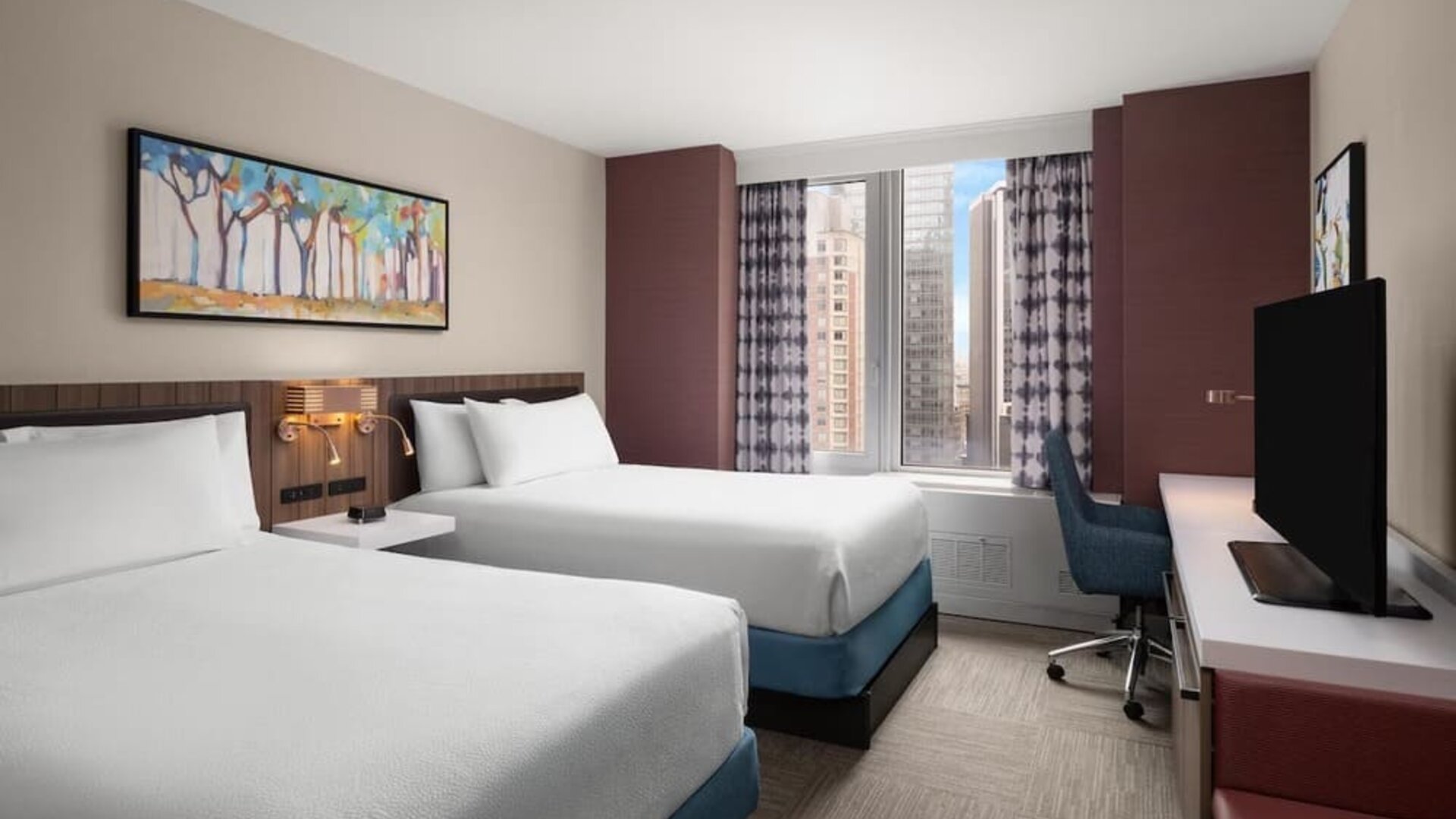 Double queen room with city view and desk at Hilton Garden Inn New York/West 35th Street.