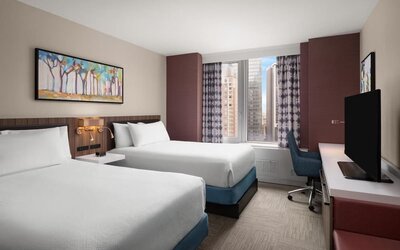 Double queen room with city view and desk at Hilton Garden Inn New York/West 35th Street.