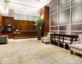 Spacious hotel lobby with seating at Hilton Garden Inn New York/West 35th Street.