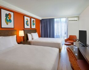 Double queen guest room with contemporary décor at Courtyard Waikiki Beach.