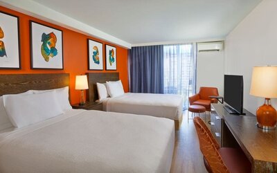 Double queen guest room with contemporary décor at Courtyard Waikiki Beach.