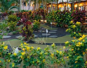 Lush mini golf garden area at Courtyard Waikiki Beach.