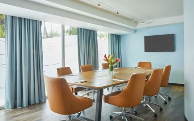 Modern meeting room with large windows at Courtyard Waikiki Beach.