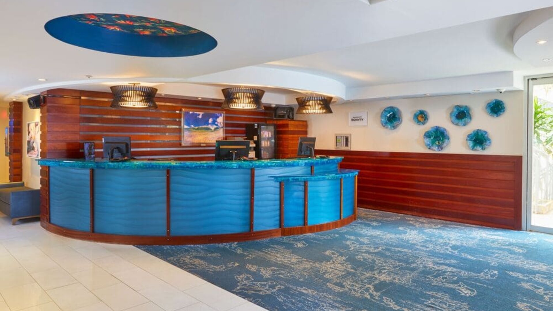 Colorful reception desk and lobby area at Courtyard Waikiki Beach.