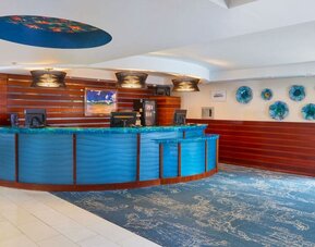 Colorful reception desk and lobby area at Courtyard Waikiki Beach.