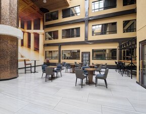 Open atrium seating area inside Hotel Montreal Metropolitan, An Ascend Collection Hotel.