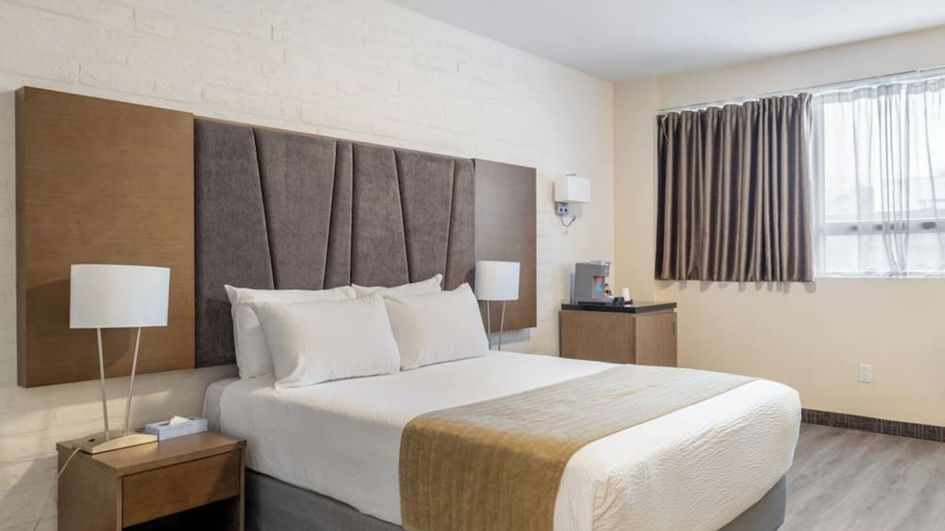 Contemporary king guest room with soft lighting and spacious layout at Hotel Montreal Metropolitan, An Ascend Collection Hotel.