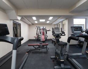 Fitness center with cardio machines and strength equipment at Hotel Montreal Metropolitan, An Ascend Collection Hotel.