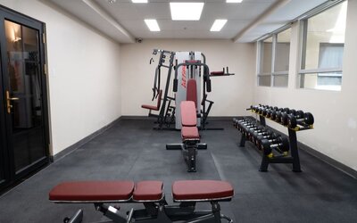 Hotel gym with free weights and workout benches at Hotel Montreal Metropolitan, An Ascend Collection Hotel.