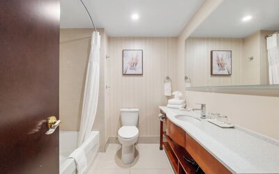 Modern bathroom with large vanity and bathtub at Hotel Montreal Metropolitan, An Ascend Collection Hotel.
