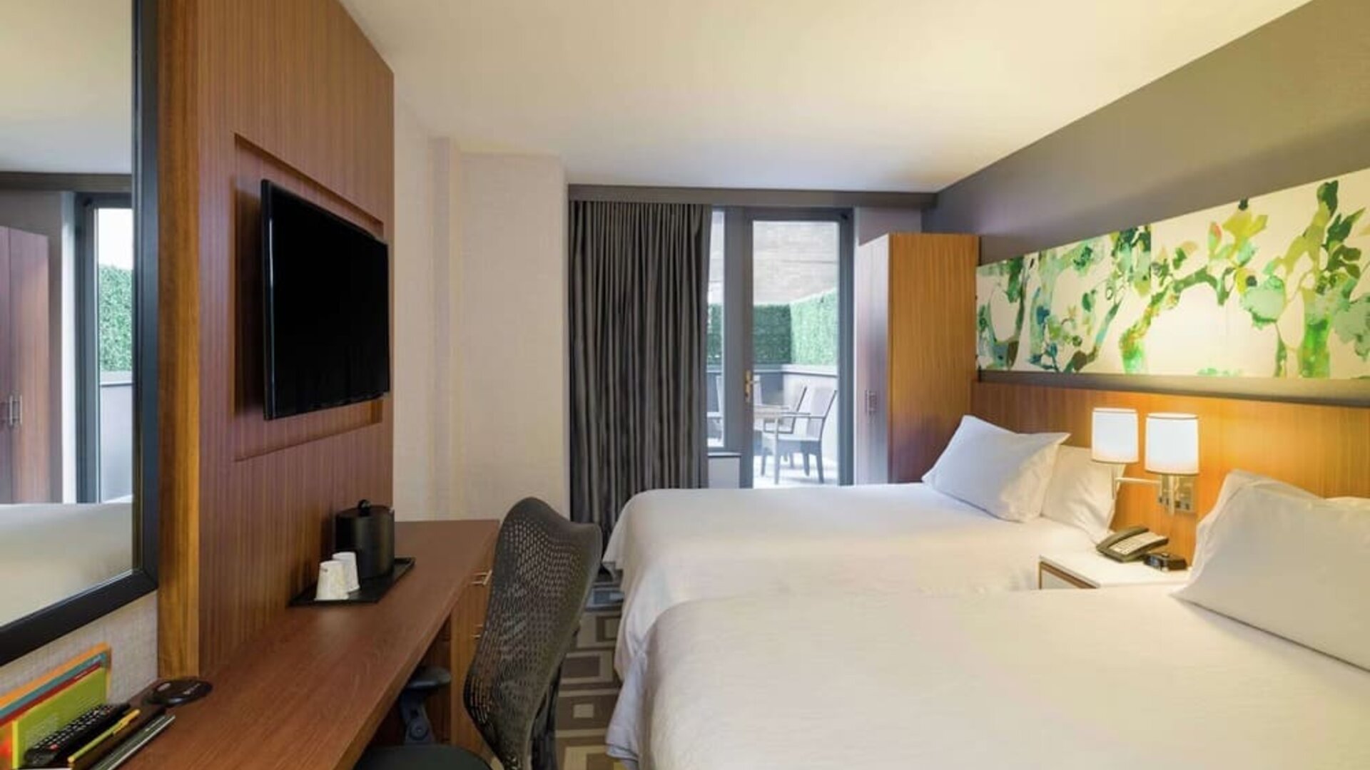 Modern guest room with two double beds and private balcony at Hilton Garden Inn New York Central Park South-Midtown West.