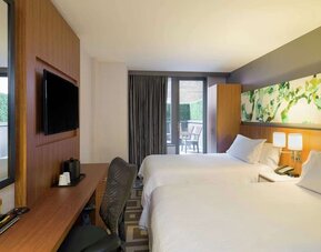 Modern guest room with two double beds and private balcony at Hilton Garden Inn New York Central Park South-Midtown West.