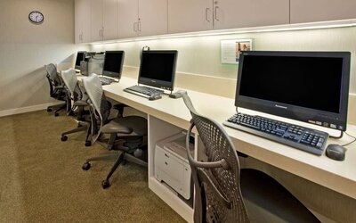 Business center with desktop computers and workstations at Hilton Garden Inn New York Central Park South-Midtown West.