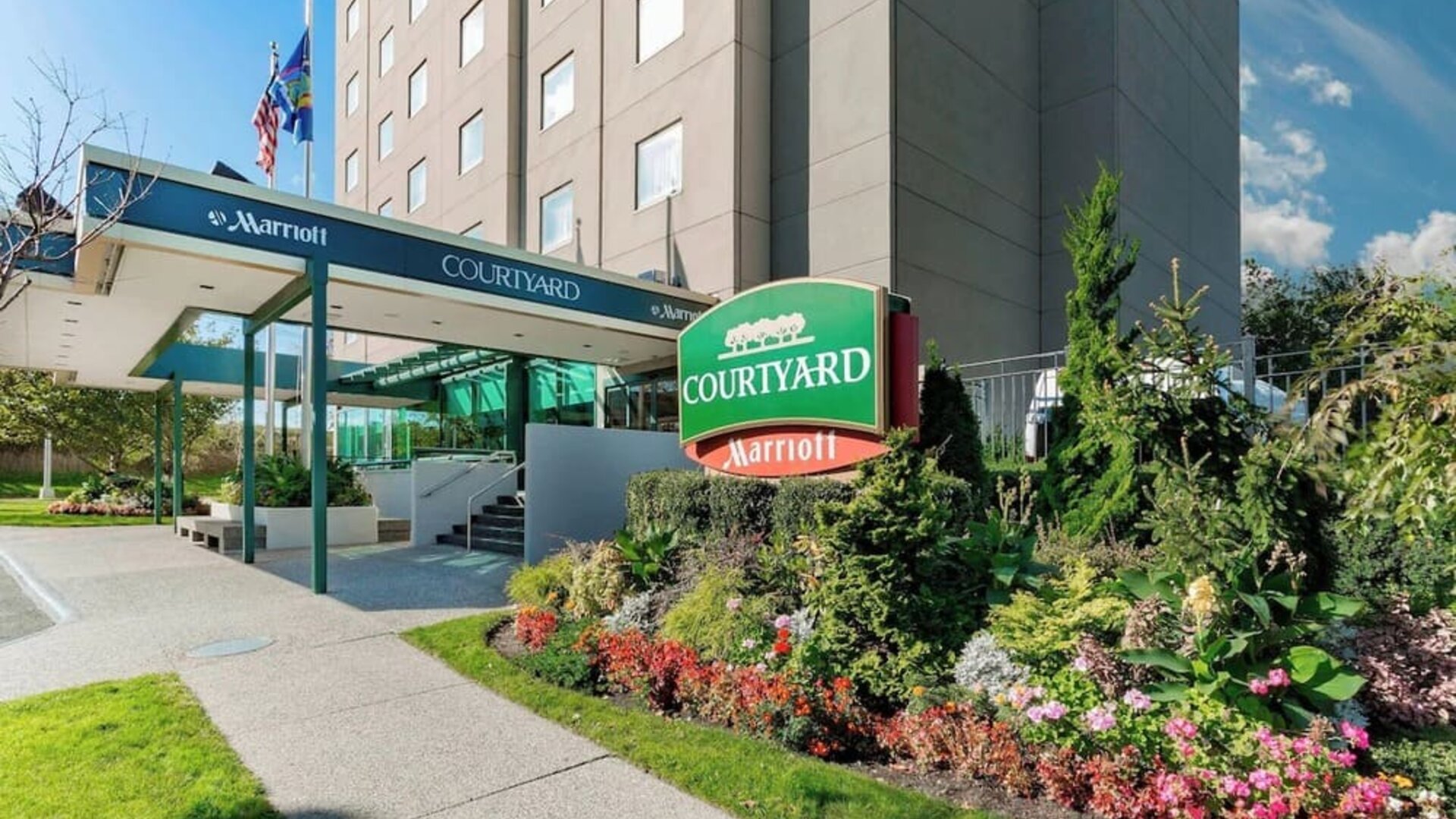 Front entrance and exterior view of Courtyard By Marriott New York JFK Airport.