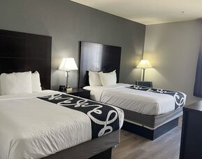 Guest room with two double beds and modern décor at La Quinta Inn & Suites By Wyndham Houston Energy Corridor.