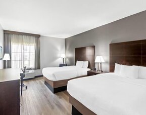 Spacious guest room with two beds, workspace, and large windows at La Quinta Inn & Suites By Wyndham Houston Energy Corridor.
