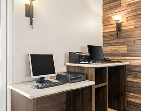Business center with computers and printing facilities at La Quinta Inn & Suites By Wyndham Houston Energy Corridor.