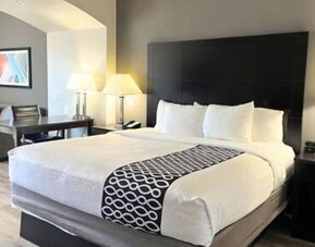 Spacious king room with seating area and modern furnishings at La Quinta Inn & Suites By Wyndham Houston Energy Corridor.