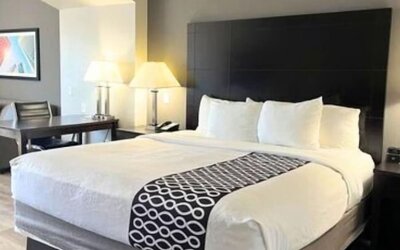 Spacious king room with seating area and modern furnishings at La Quinta Inn & Suites By Wyndham Houston Energy Corridor.