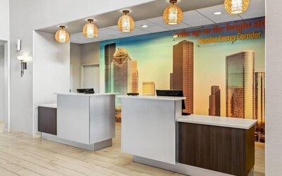 Reception desk and check-in area at La Quinta Inn & Suites By Wyndham Houston Energy Corridor.