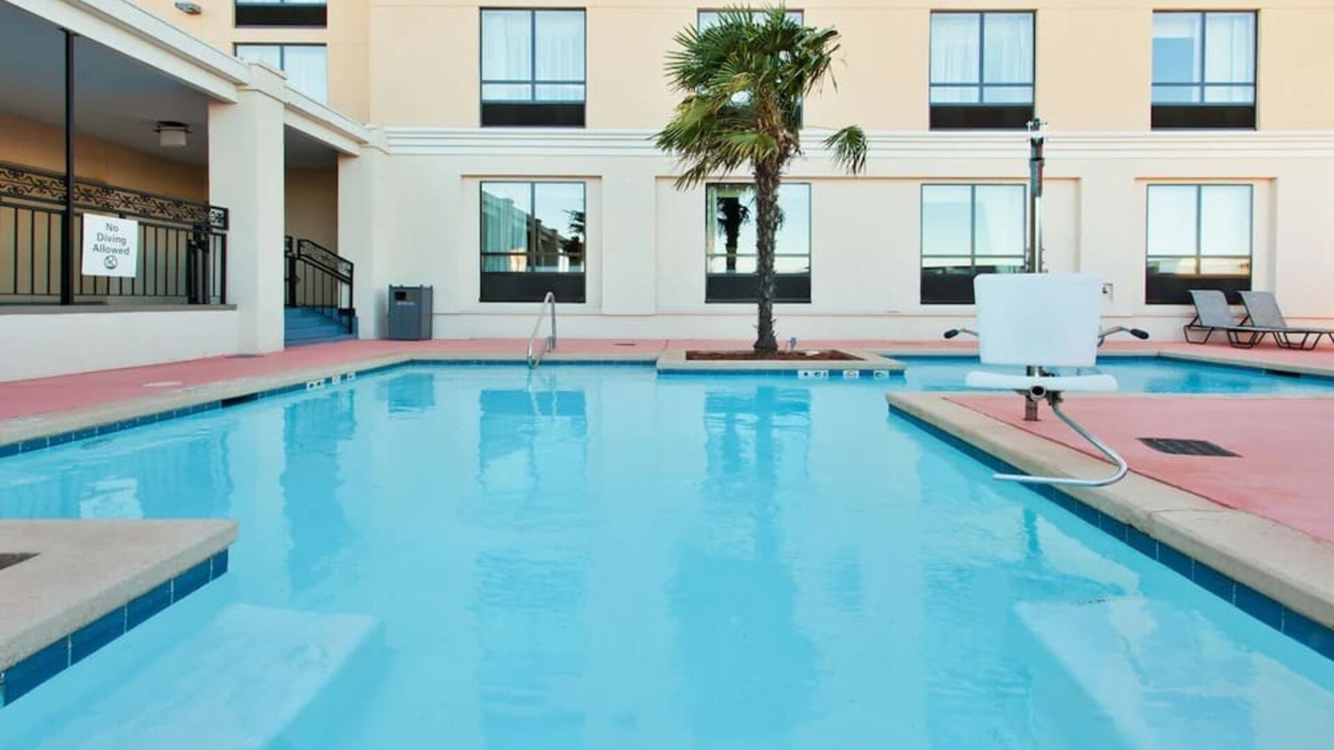 Outdoor pool area with lounge seating at Holiday Inn Downtown Shreveport.