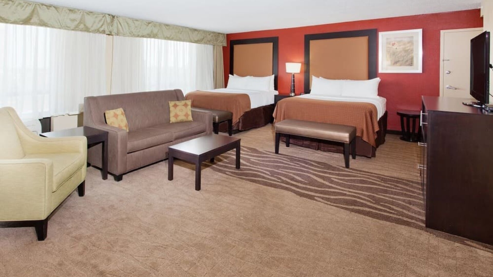 Double queen guest room with workspace and modern furnishings at Holiday Inn Downtown Shreveport.