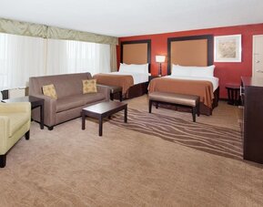 Double queen guest room with workspace and modern furnishings at Holiday Inn Downtown Shreveport.