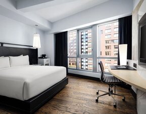 Modern king guest room with workspace and city views at Hyatt Union Square New York.