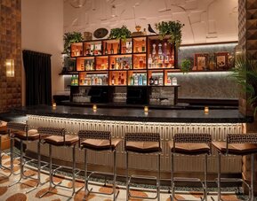 Stylish cocktail bar with ambient lighting and upscale seating at Hyatt Union Square New York.