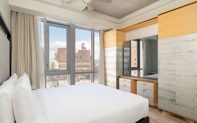 Bright guest room with floor-to-ceiling windows and modern furnishings at Hyatt Union Square New York.
