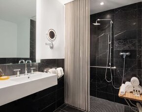 Luxury bathroom with walk-in rainfall shower and marble finishes at Hyatt Union Square New York.
