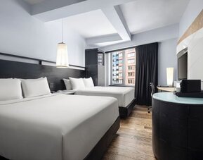 Double queen guest room with modern design and city views at Hyatt Union Square New York.