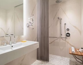 Modern marble bathroom with accessible walk-in shower at Hyatt Union Square New York.