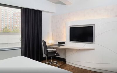 Guest room workspace with mounted television and modern desk setup at Hyatt Union Square New York.