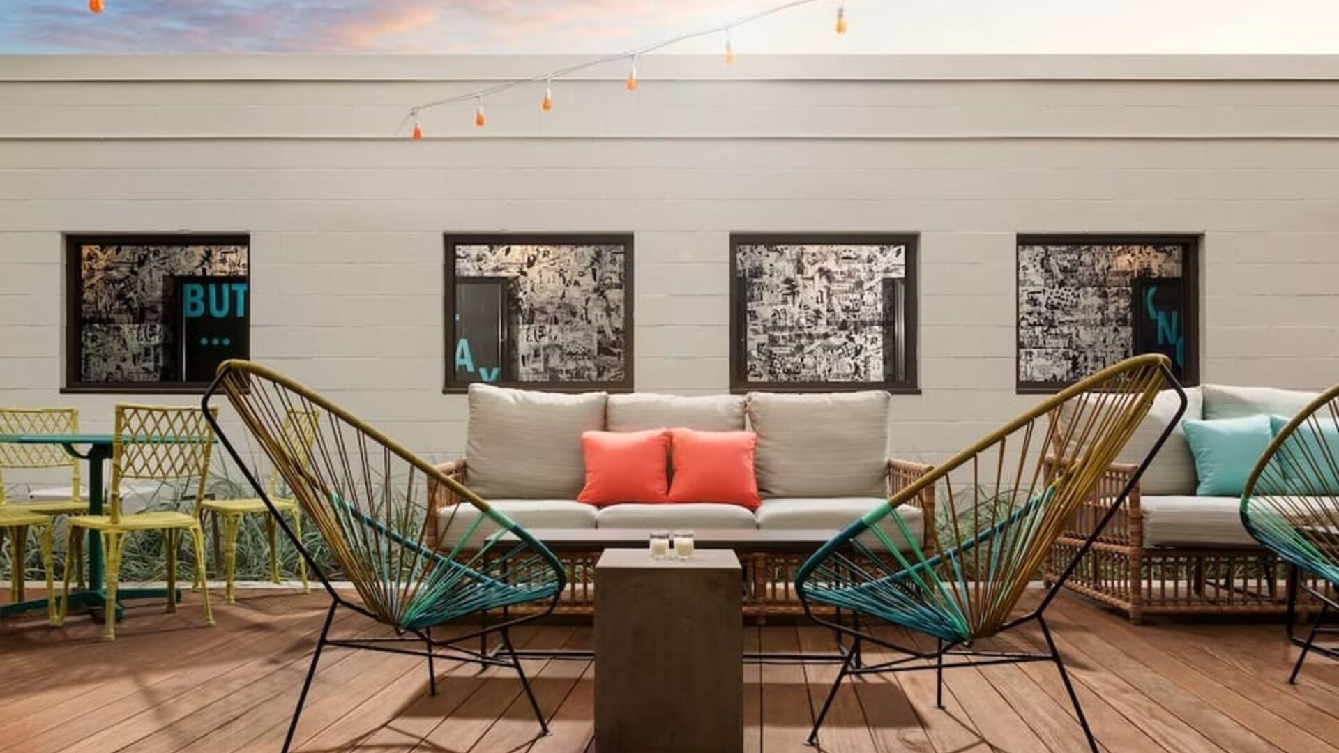 Rooftop outdoor seating area with stylish lounge furniture at Hotel Studio Allston.
